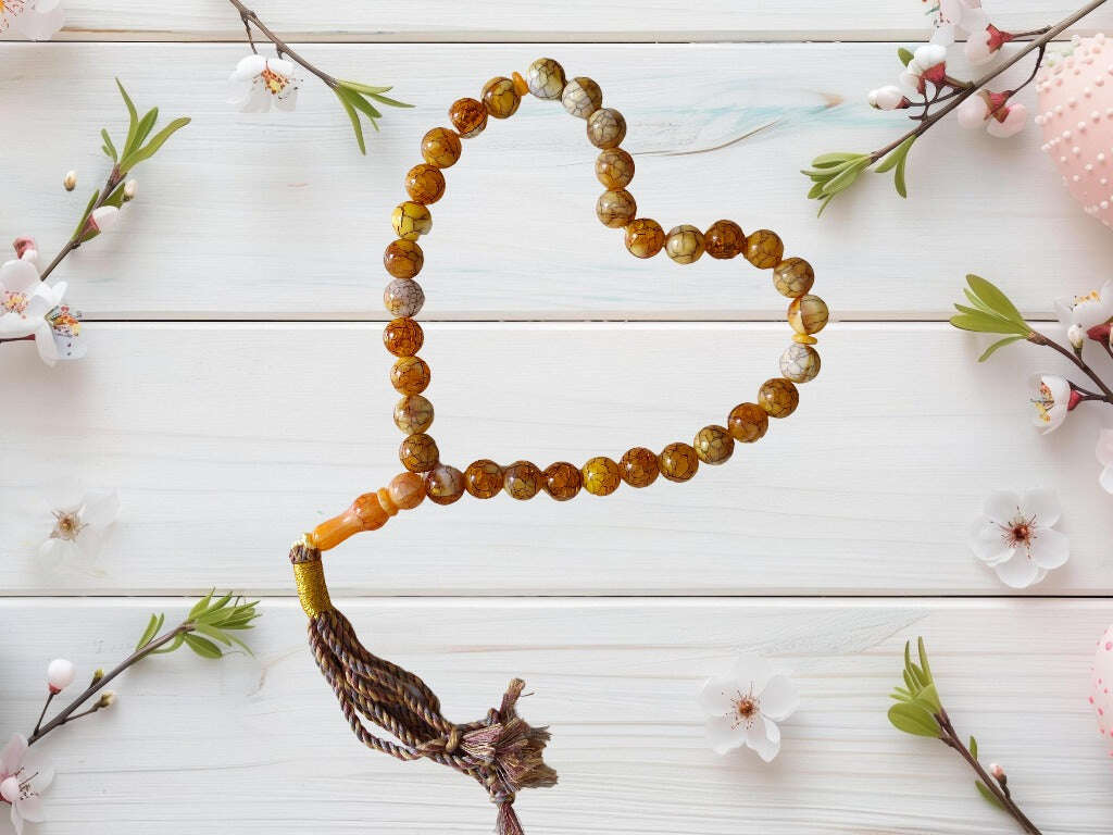 Colourful acrylic Muslim Tasbih with yellow, white, and orange beads – 33-bead Islamic prayer aid with black patterns